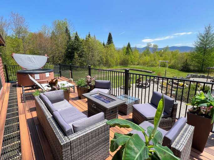 Updated deck with firepit table, hot tub, and various seating options