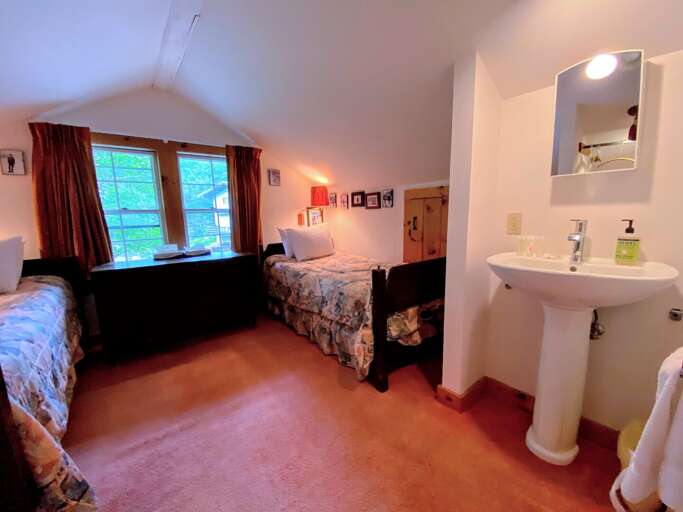 This bedroom also features ensuite sink adjacent to the bathroom.