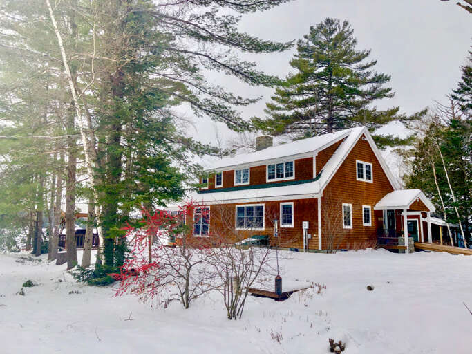View of the lake house and gazebo during winter. View of the lake house and gazebo during winter.