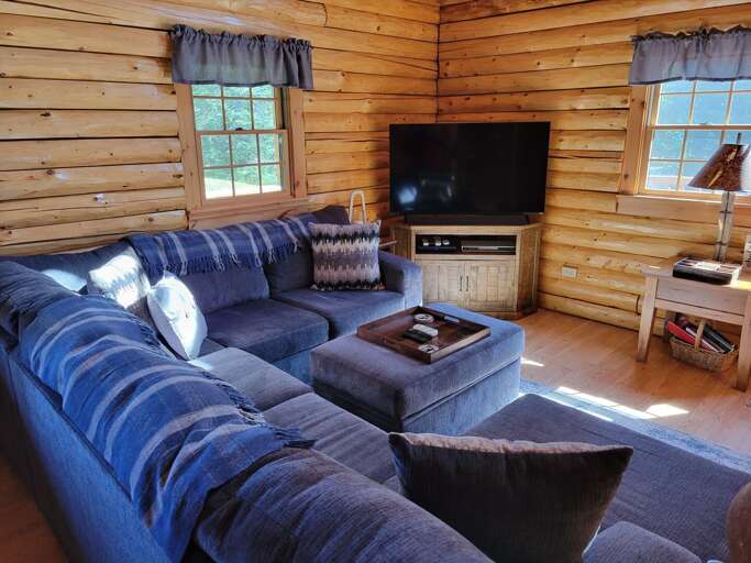 Wooden Cabin Interior With Sectional Sofa And Television