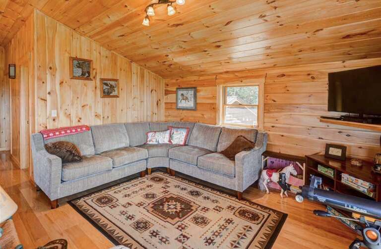 Additional sleeping options features a Queen sleeper Sofa located in the lower living room.