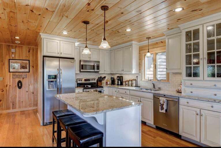 The kitchen has a cozy breakfast bar that seats 3!