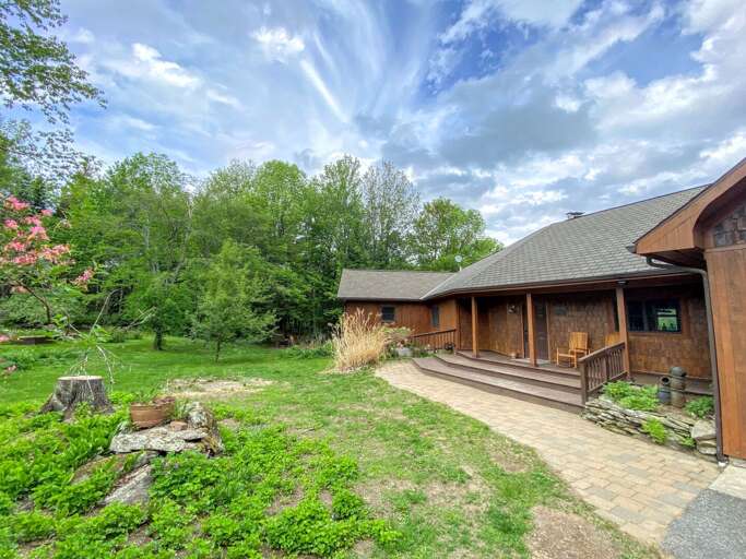 Rustic House With Landscaped Garden Under Blue Skies