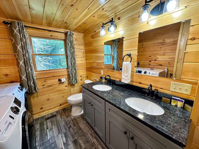 The shared main level bath with 2 sinks and laundry.
