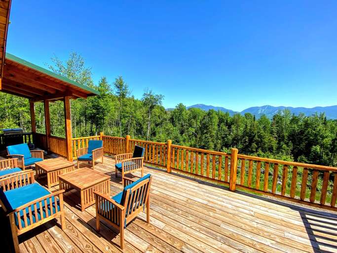 Wooden Deck With Chairs Overlooking Mountains