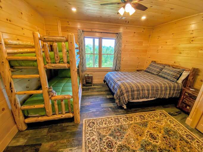 Guest Bedroom #3 is located on the lower level and features a Queen bed and Twin/Twin bunk bed. Sleeps 4.