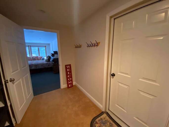 Interior entry to lower level apartment from 1st level. Garage and utilities also located on this level.