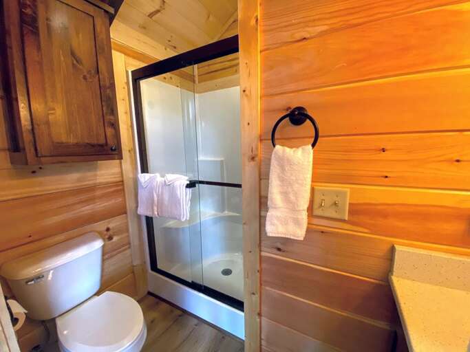 Three-quarter bathroom (sink, shower and toilet) with towels provided.