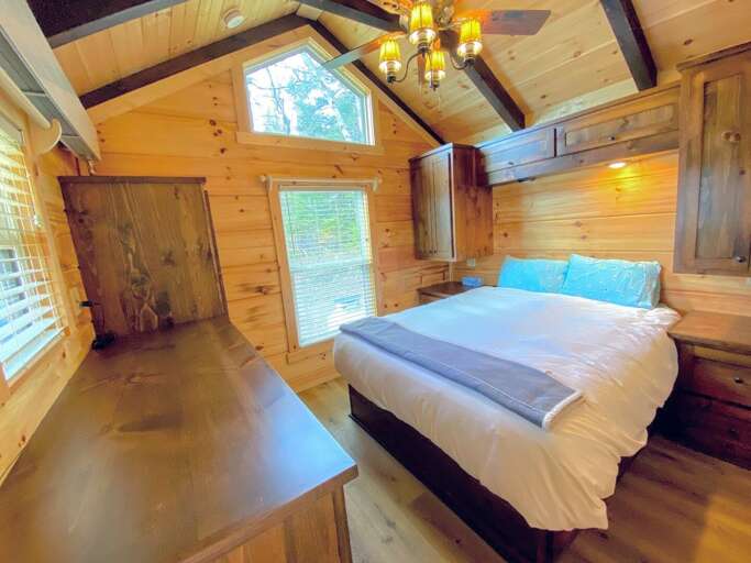 The bedroom is outfitted with a queen-sized bed with built-in storage. Linens provided.