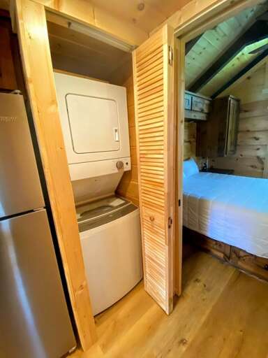 The washer and dryer are between the kitchen and the master's bedroom, fronting the bathroom.