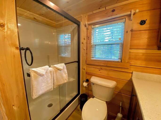 A comfortably spaced three-quarter bathroom (sink, toilet and shower) with towels. A comfortably spaced three-quarter bathroom (sink, toilet and shower) with towels.