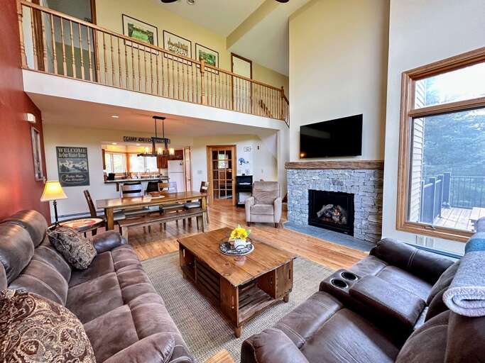 Main Level Living Area with gas fireplace, TV, deck access and adjacent to kitchen and dining area Main Level Living Area with gas fireplace, TV, deck access and adjacent to kitchen and dining area