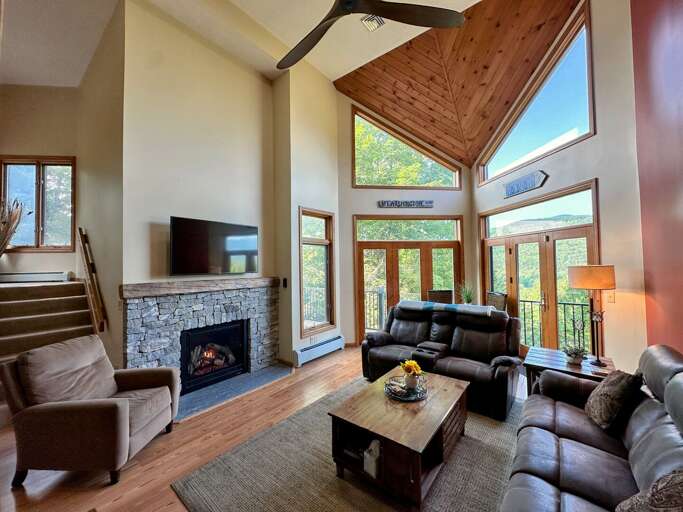 Main Level Living Area with gas fireplace, TV, deck access and adjacent to kitchen and dining area Main Level Living Area with gas fireplace, TV, deck access and adjacent to kitchen and dining area