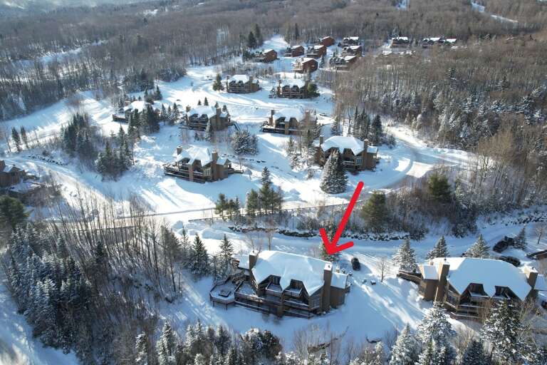 Aerial View Of Snow-covered Buildings With Red Arrow Pointing At One