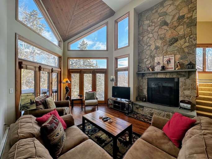 Main Level Living Area with Wood Burning Fireplace, TV and deck access Main Level Living Area with Wood Burning Fireplace, TV and deck access