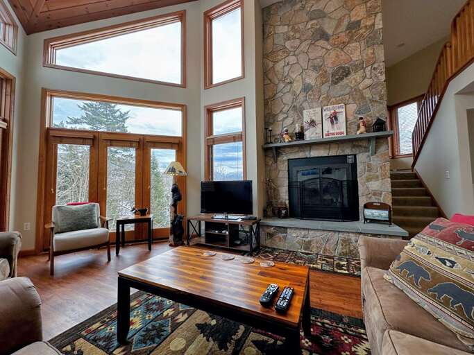 Main Level Living Area with Wood Burning Fireplace, TV and deck access Main Level Living Area with Wood Burning Fireplace, TV and deck access