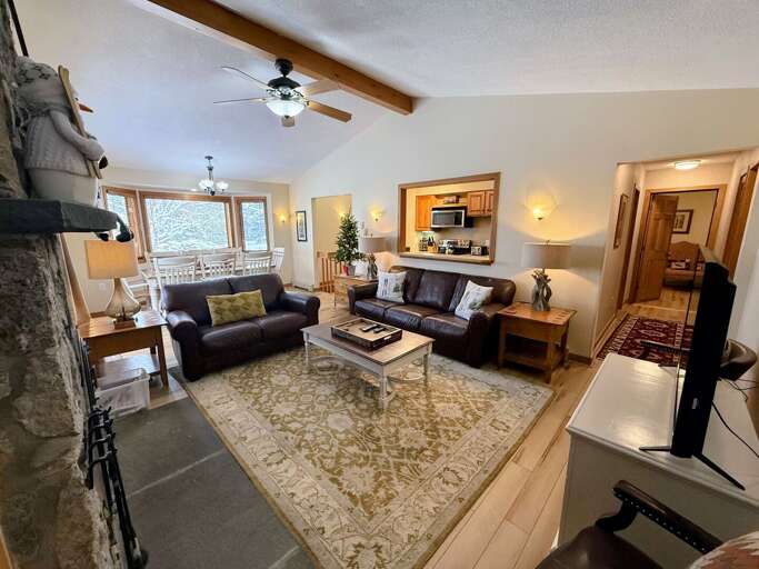Dining/Living Area: Open concept space offers dining table with room for 8 and comfortable couches to relax by the stone fireplace. TV with high speed wi-fi included.