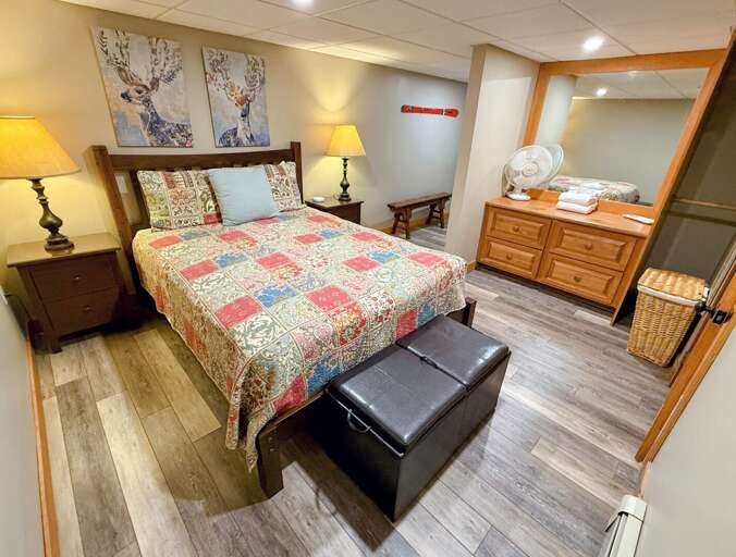 Guest Room #2: Located on the lower level and features a queen bed. Sleeps 2. Egress provided via bulkhead to the yard. No windows.