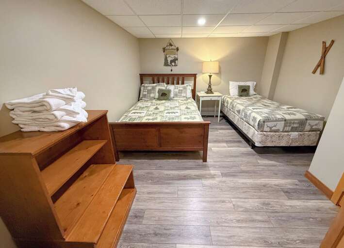 Guest Room #3: Located on the lower level and features a double bed and a twin bed. Sleeps 3. NOTE: This room has no egress. No windows.