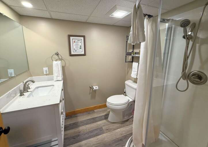 Lower level shared bathroom with shower.