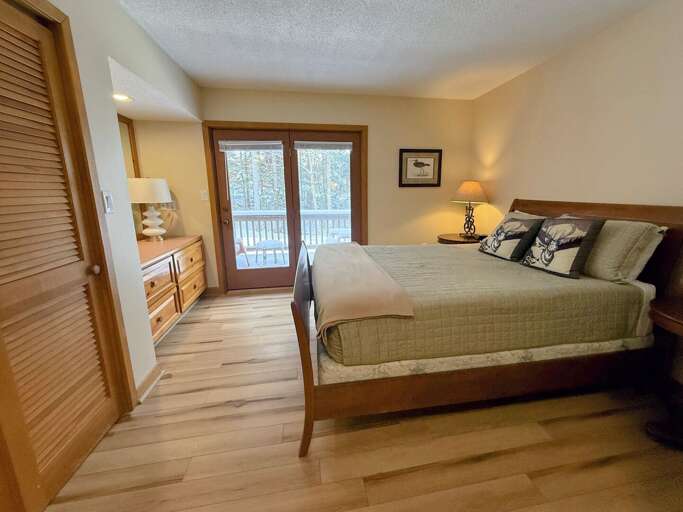 Primary Bedroom: Located on the main level and features a queen size bed, ensuite bathroom, large closet and private deck. Sleeps 2.