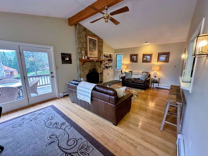 Dining/Living Area: Open space with comfortable furniture that surrounds a stone fireplace. Please note - no TV here. Dining/Living Area: Open space with comfortable furniture that surrounds a stone fireplace. Please note - no TV here.