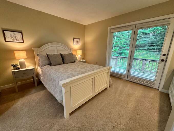 Main Level Queen bedroom with ensuite full bath and walkout private deck Main Level Queen bedroom with ensuite full bath and walkout private deck