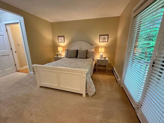 Main Level Queen bedroom with ensuite full bath and walkout private deck Main Level Queen bedroom with ensuite full bath and walkout private deck