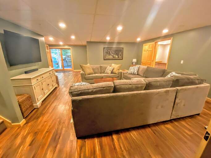 Lower level: Extra living/game room with beautiful comfortable furniture, TV and access to back yard.