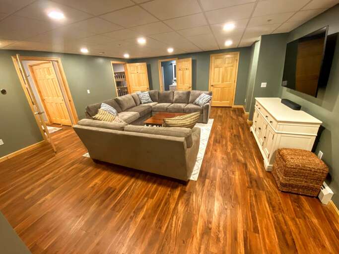 Lower level: Extra living/game room with beautiful comfortable furniture, TV and access to back yard.