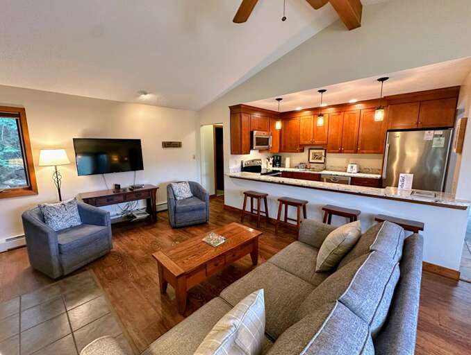 Interior Living Space With Kitchen, Sofa, And TV