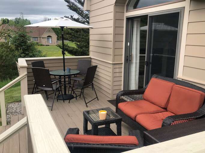 Back deck offers new dining furniture and outdoor grill!
