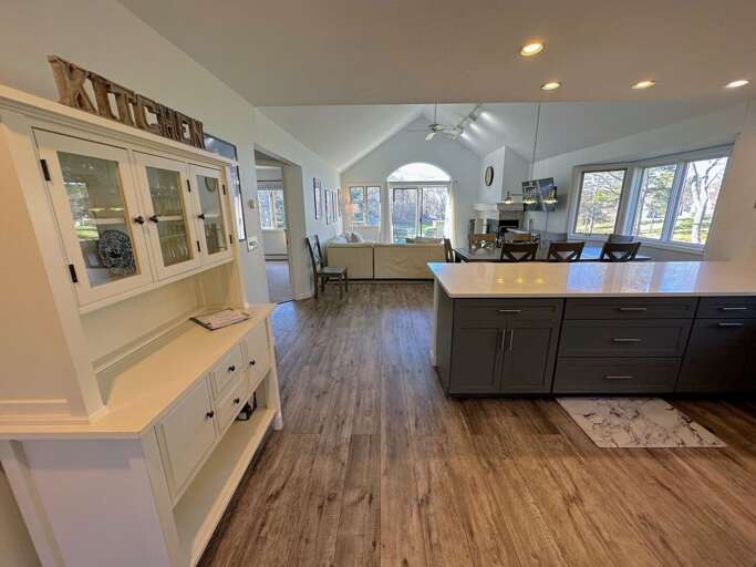 The inviting open concept plan begins with the kitchen with large peninsula and barstools to relax while preparing in the kitchen.