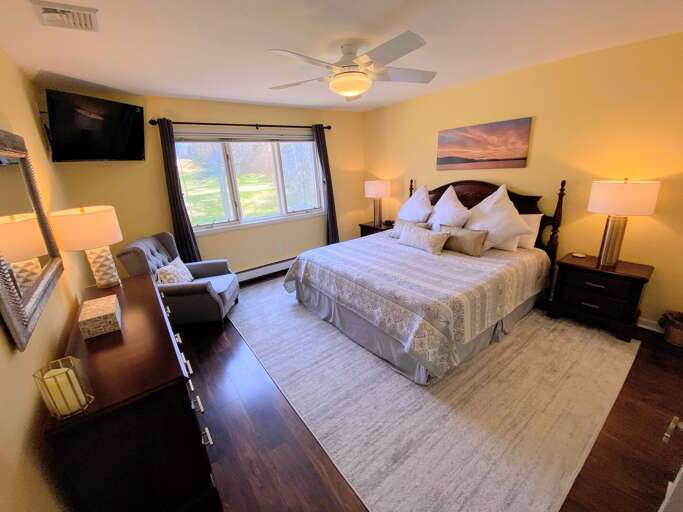 The master bedroom is located on the main level and features a King size bed, TV, ceiling fan and attached bath. Sleeps 2. The master bedroom is located on the main level and features a King size bed, TV, ceiling fan and attached bath. Sleeps 2.