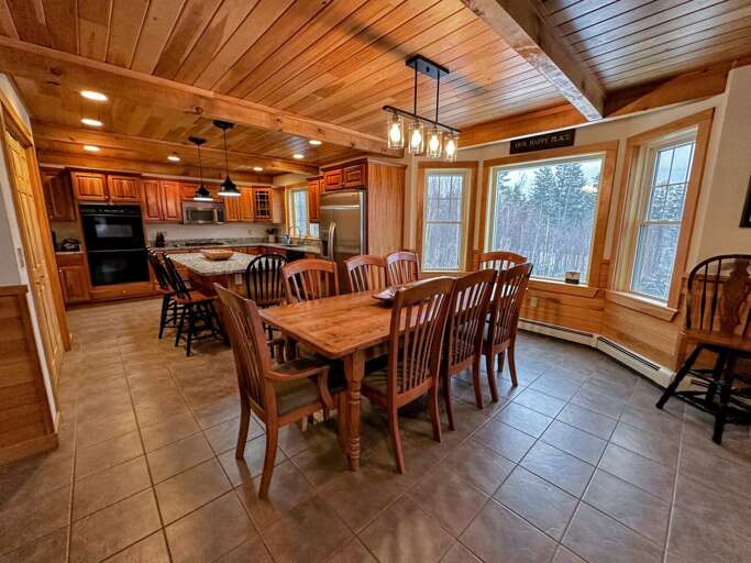 Full kitchen that features double ovens.