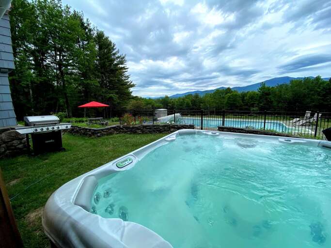 View with hot tub and pool