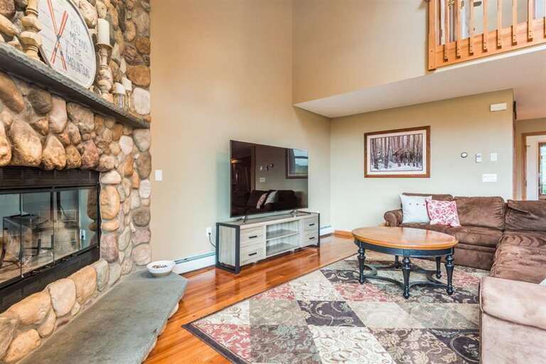 Living Room With Stone Fireplace And Brown Sofa Living Room With Stone Fireplace And Brown Sofa