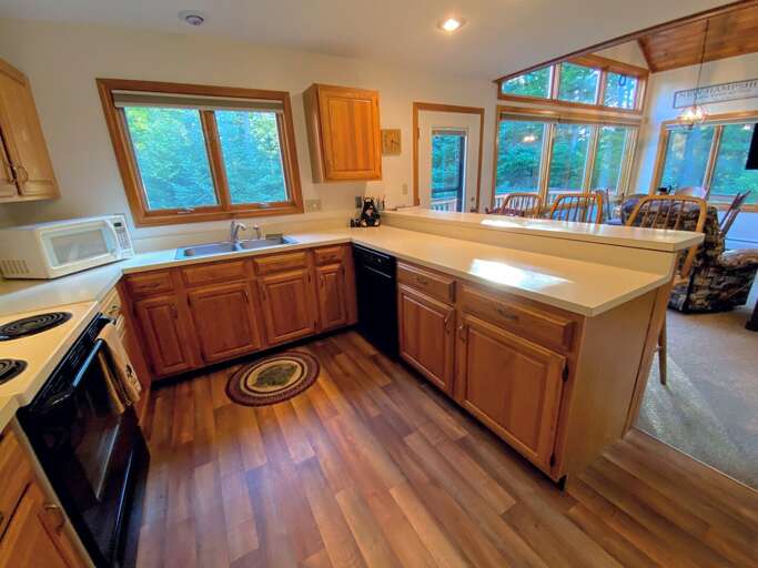 The kitchen is fully stocked for all your cooking needs and offers a coffee maker. The kitchen is fully stocked for all your cooking needs and offers a coffee maker.