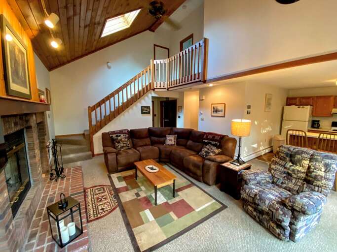 Living Room With Sofa, Fireplace, And Staircase Living Room With Sofa, Fireplace, And Staircase