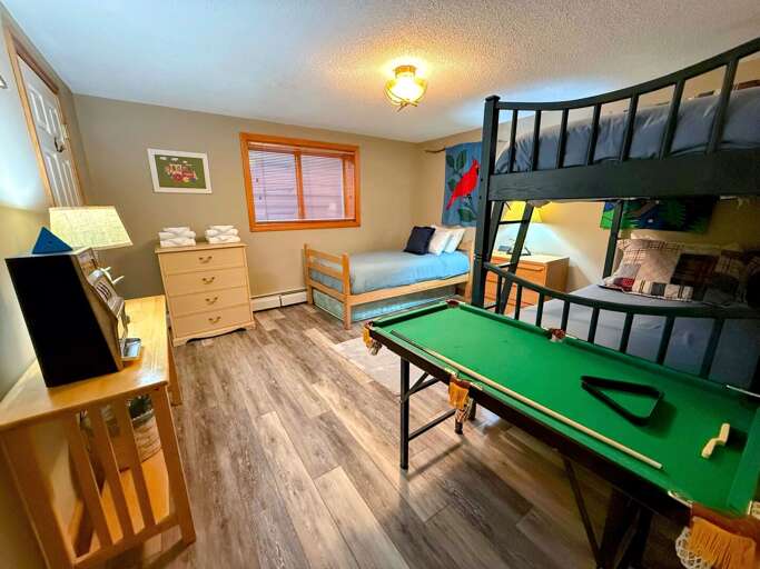 Lower Level bedroom with Twin-over-Twin bunk bed and separate Twin bed Lower Level bedroom with Twin-over-Twin bunk bed and separate Twin bed