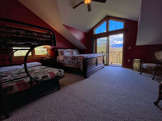 Upper level bedroom with King bed and full/full bunk fireplace and deck.