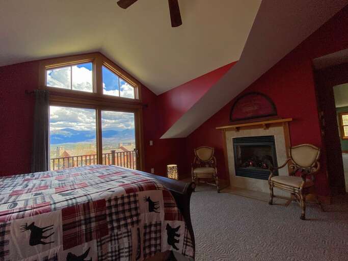 Upper level bedroom with King bed and full/full bunk fireplace and deck.