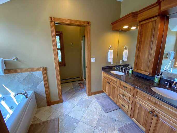 Upper level bedroom with King bed and full/full bunk fireplace and deck.