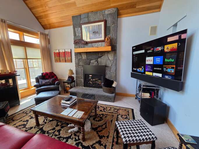 Striking stone fireplace is the centerpiece in the living area