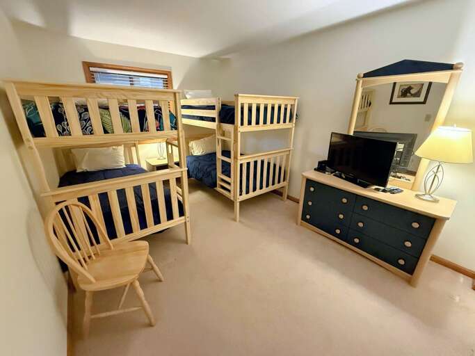 Bunk room with two twin-over-twin bunks and a TV Bunk room with two twin-over-twin bunks and a TV