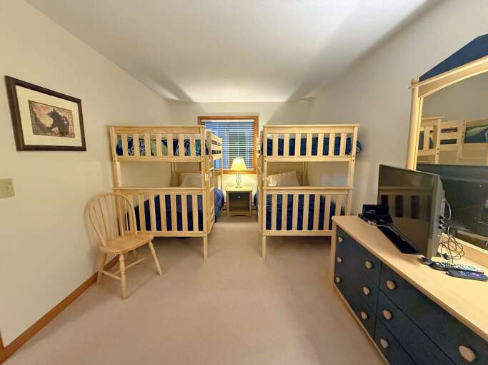 Bunk room with two twin-over-twin bunks and a TV Bunk room with two twin-over-twin bunks and a TV