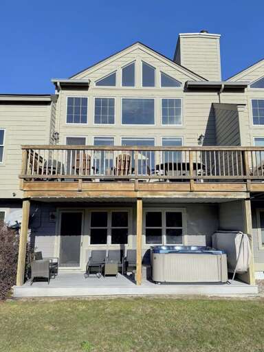 Multi-level Building With Balconies, Backyard Hot Tub Multi-level Building With Balconies, Backyard Hot Tub