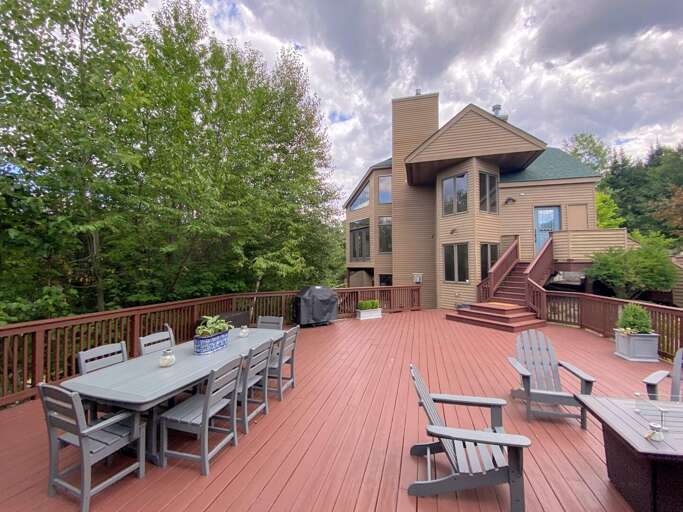 Large private deck with outdoor dining table, propane fire table, and propane grill