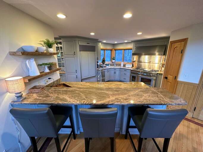 Large updated kitchen with granite countertops, upscale appliances and breakfast bar