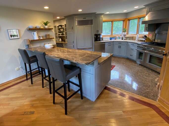 Large updated kitchen with granite countertops, upscale appliances and breakfast bar